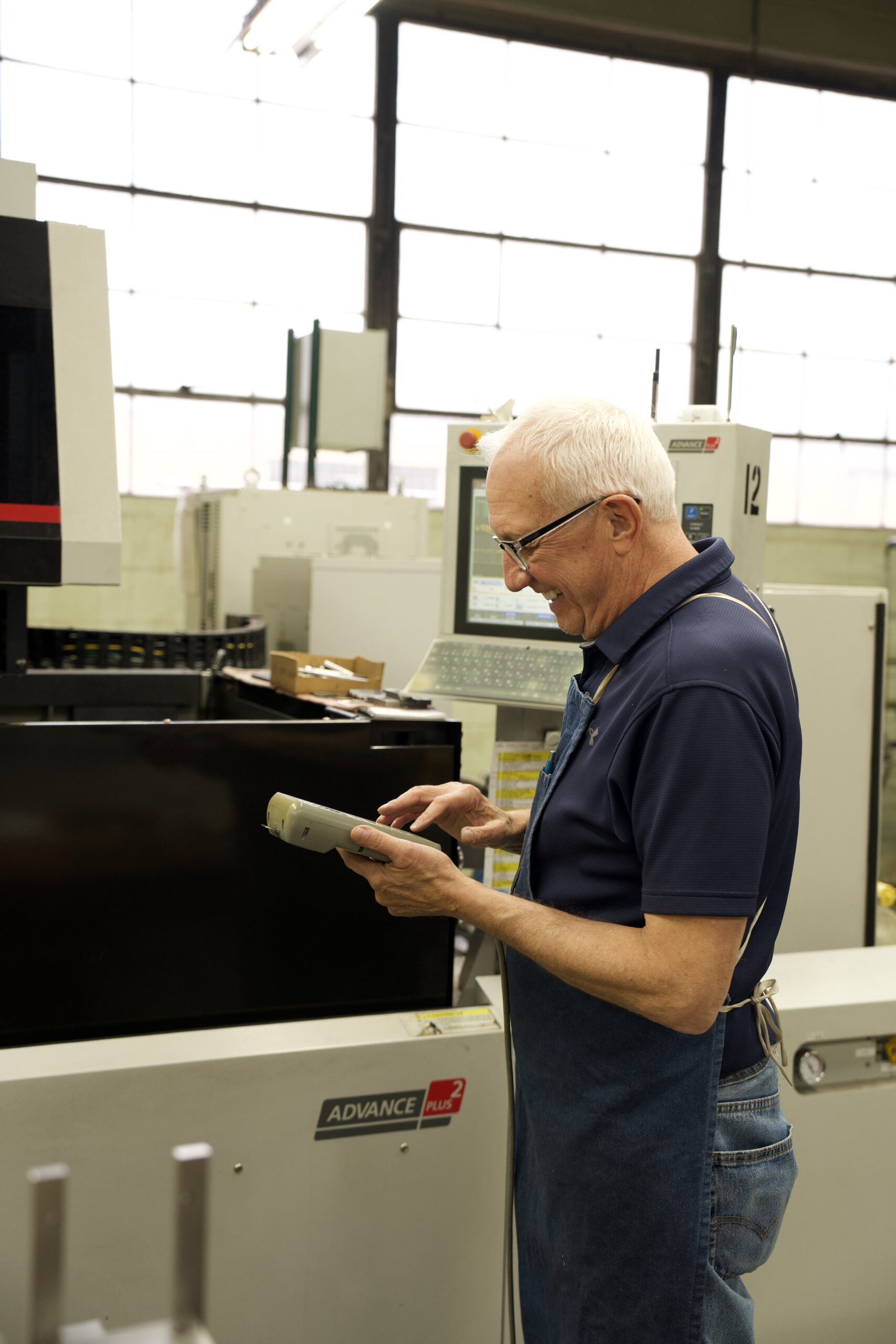Manor Tool operator inspecting a finished component — Schiller Park, IL