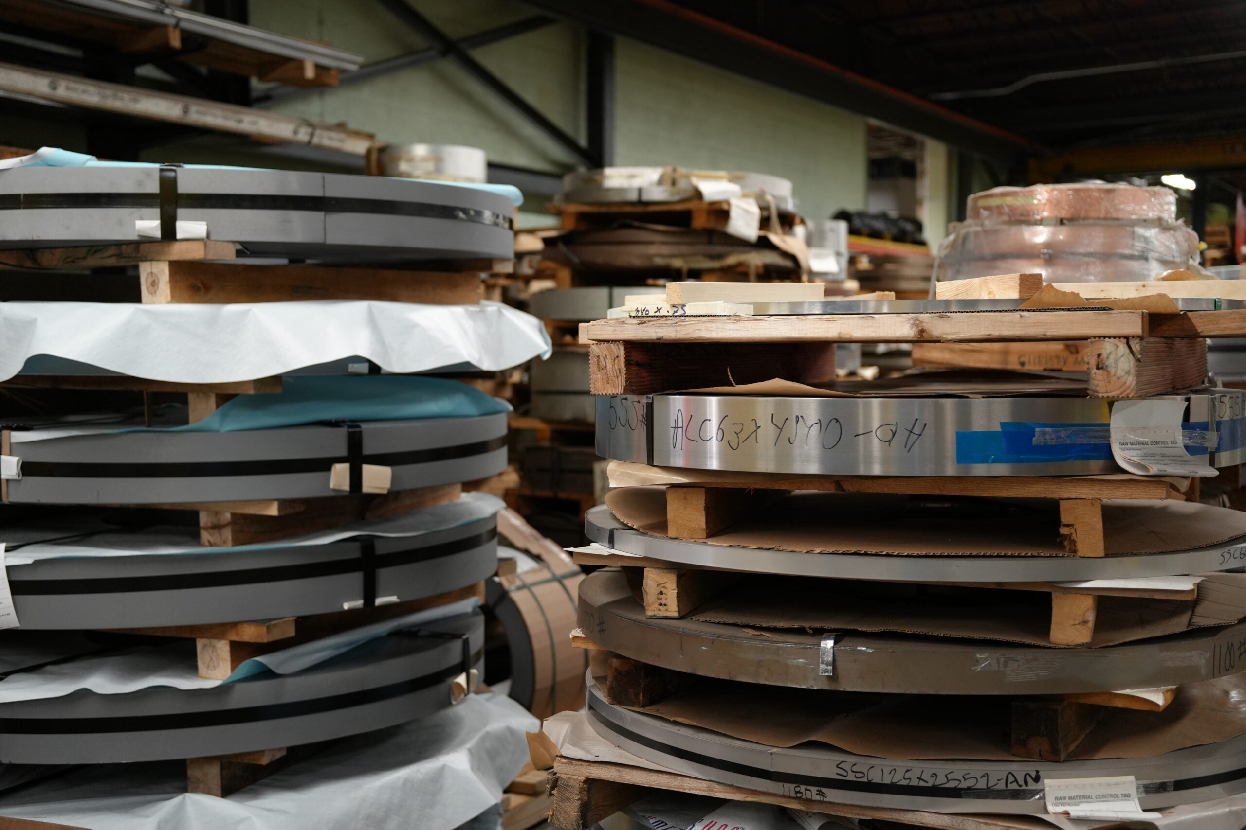 Flat metal sheet stock staged for deep drawn stamping at Manor Tool